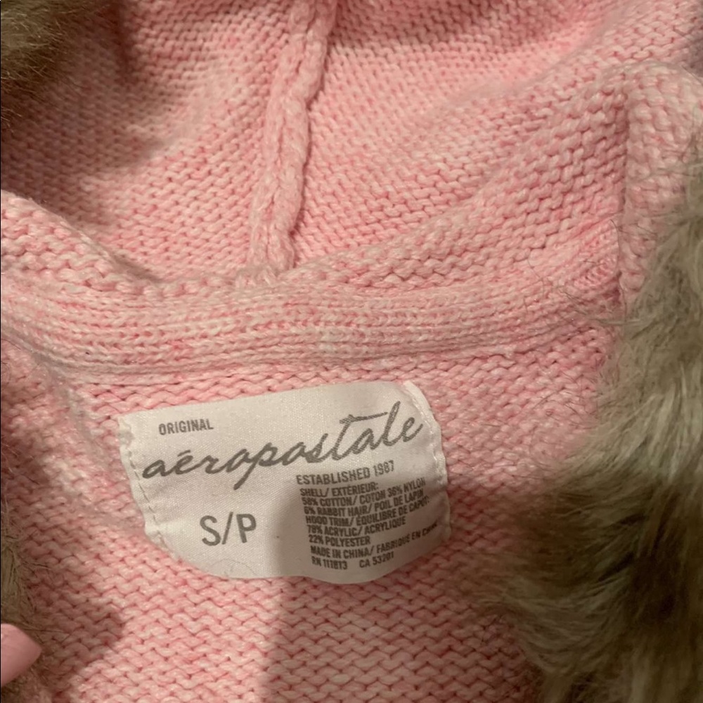 A white and pink women’s small sweater with hood